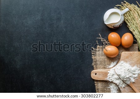 Baking powder milk and eggs on chalkboard for background