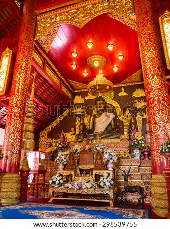 CHIANG RAI, THAILAND - JANUARY 5: Interior of Thai northern temple and Buddha sculpture on January 5, 2015 in Wat Phra Kaeo. This Temple is famous as the original home of the translucent green Buddha.