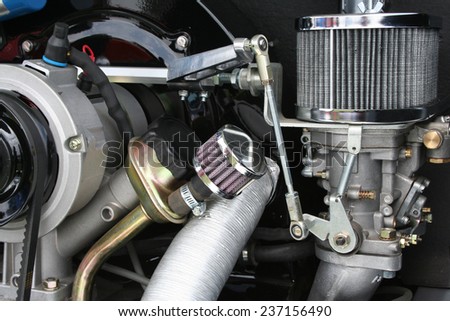 Air cooled engine detail showing air filter, alternator carburetor and pulley.