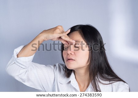 Asian women  have a sore eyes.
