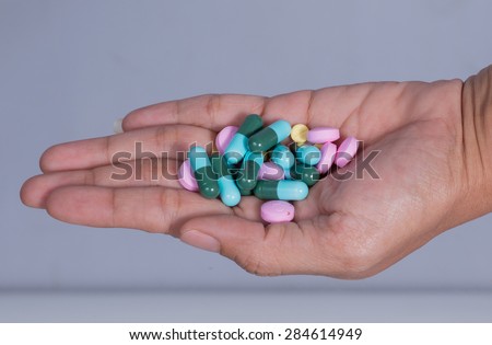 Tablets and capsules on hand.