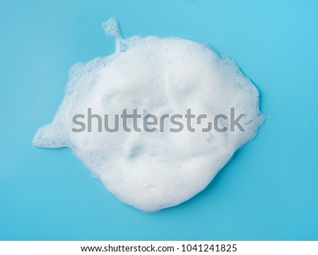Foam bubble drop on blue background on top view object beatuy health care concept design