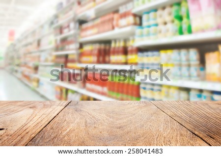Wood floor and Supermarket blur background ,Product shelf sauce
