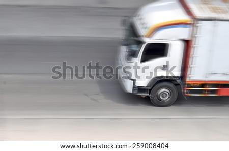 truck with freight moving fast