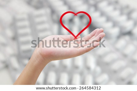 Heart in hands on pill blur background , healthy concept