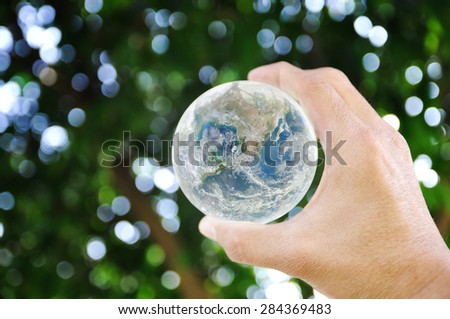 Hand holding earth on bokeh background , Elements of image are furnished by NASA