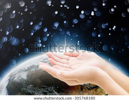 Hand on earth background , all concept , beauty ,freedom,peace ,spirituality, , Elements of image are furnished by NASA