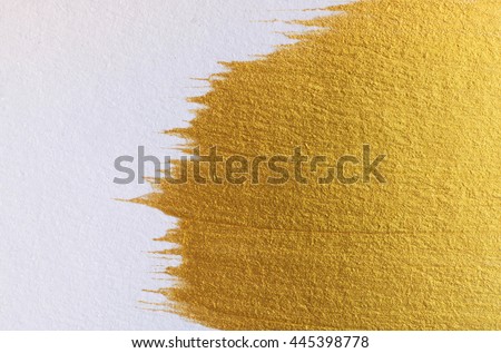 Gold acrylic paint on white paper background , gold texture free hand stoke object paint