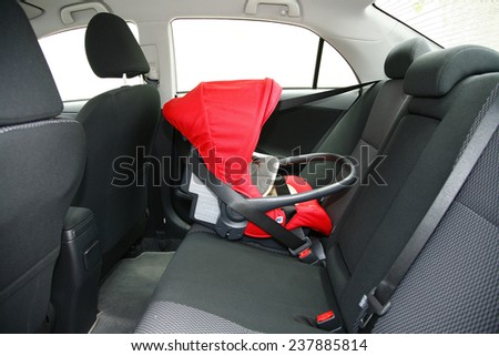 baby safety seat placing it in the car