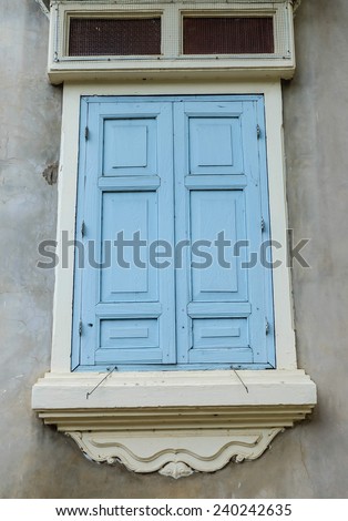 gray wall with blue window frame