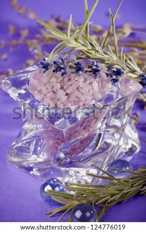 dry Lavender herbs and bath salt isolated on violet background