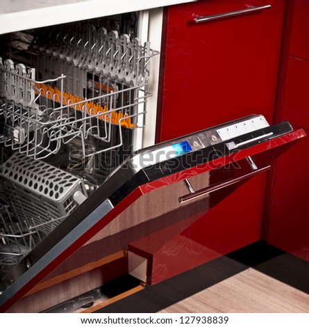 open pure empty dishwasher in kitchen furniture red
