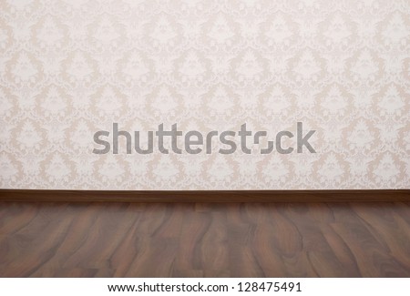 Wooden parquet floor and wallpaper on a wall