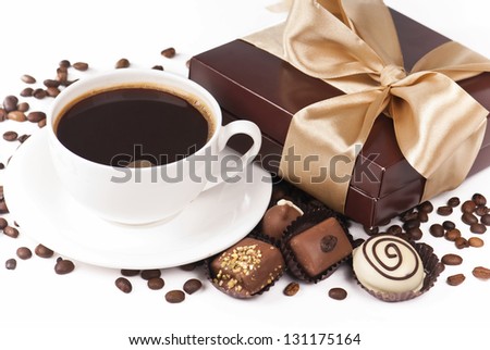 cup of coffee candies chocolate white dark dairy grains of coffee and box gift packing