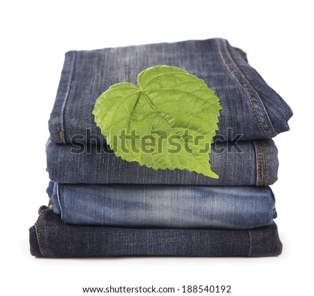 green spring leave and pile of jeans clothes