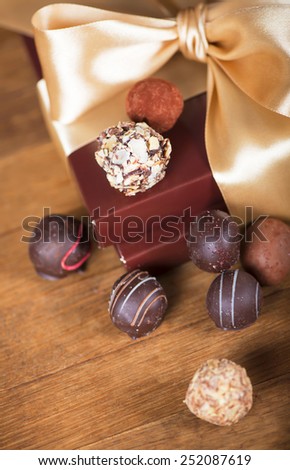 brown box with candies and golden tape, coffee grains