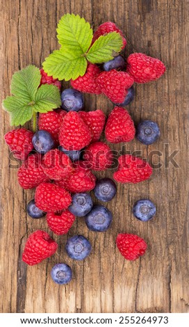 Berries on Wooden Background. Summer or Spring Organic Berry over Wood