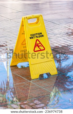 Warning sign in yellow with caution wet floor and the floor is get wet.