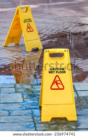 Warning sign in yellow with caution wet floor and the floor is get wet.