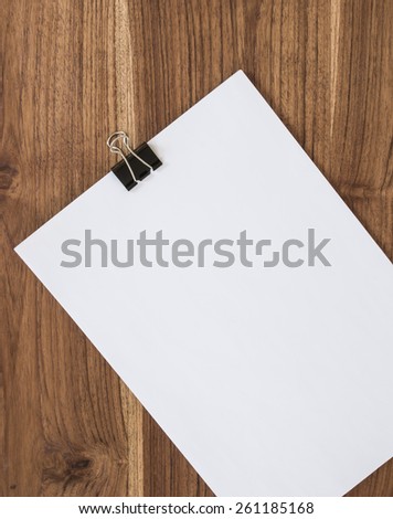 White paper with clip on board,