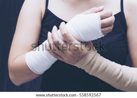 Blurry of arm splint, be in plaster cast.Injured female hand with upper part of body. Hand is bandaged with plaster.Split tone instagram like Processed.