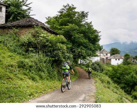 Mountain bikers in an old mountain village. Bulgaria.