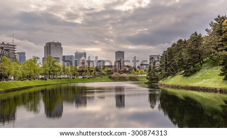 Moat around the Imperial Palace in Tokyo, Japan. The National Diet Building can be seen left of center in the background. Photograph shot on April 11, 2015