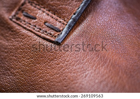 Brown leather shoes on a black wooden floor