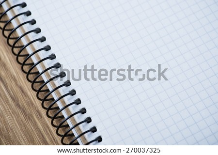 Blank spiral notebook on an oak wood table