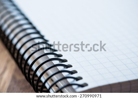 Blank spiral notebook on an oak wood table selective focus