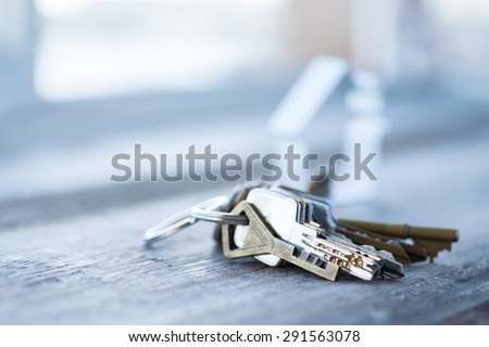 A bunch of vintage keys with metal house on the wooden table