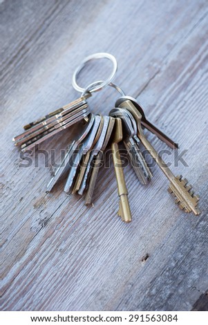 A bunch of vintage keys on the wooden table