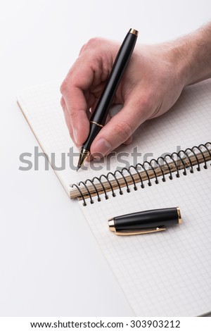Man writing a note with black ball pen in his hand over the white background, isolated