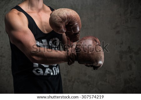 Tough male in vintage boxing gloves