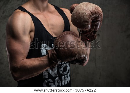 Tough male in vintage boxing gloves