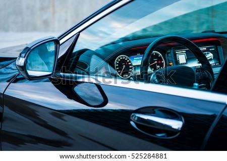 Luxury car interior details. Dashboard and steering wheel