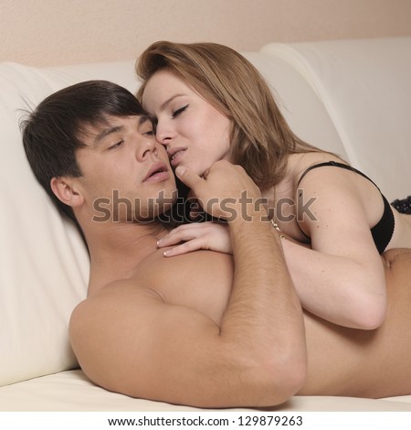 Loving couple laying in bad.