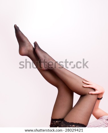 Elegant female legs in stockings isolate