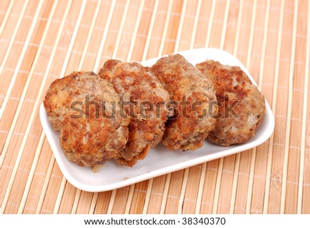 Cutlets in a plate on a bamboo background