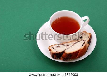 Cup of tea with a bakery on a green background