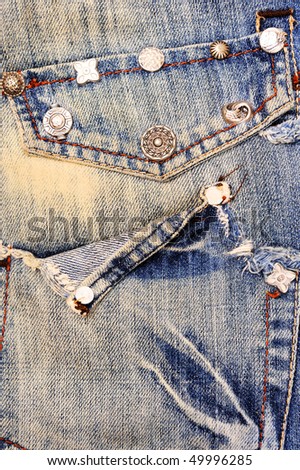 Jeans with pocket and rivets, denim background