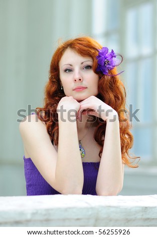 Lovely woman with a flower in her hairs