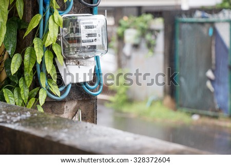 home of electric accumulateur or batterie install on electricity post. Green plant grow over electric wire.