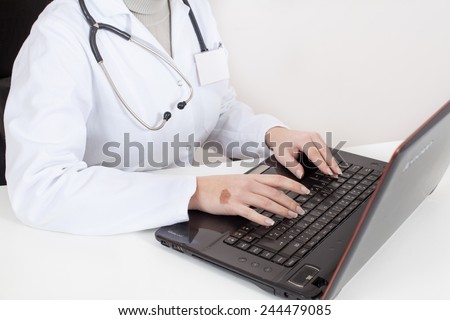 nurse typing on a laptop