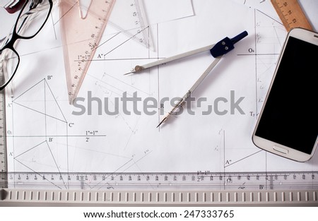architect desk with paper, ruler, compasses and mobile phone