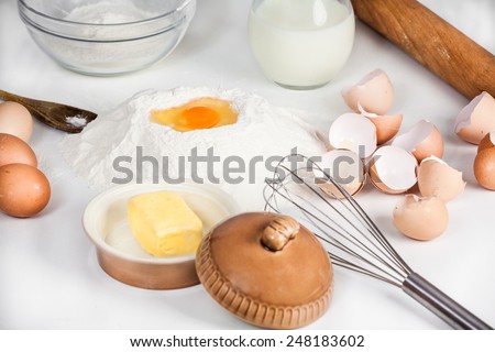 baking background with raw eggs, sugar, flour , milk and butter