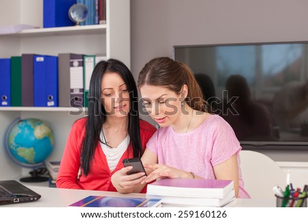 Students of college typing a message on mobile phone