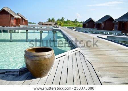 A water tank placed on the wooden road toward water villa in Maldives. It is used to clean the sands on feet when go back to the water villa