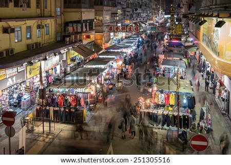Hong Kong, - February 6, 2015: People crowded in the local market, downstairs the old buildings in Mong Kok, Hong Kong.
