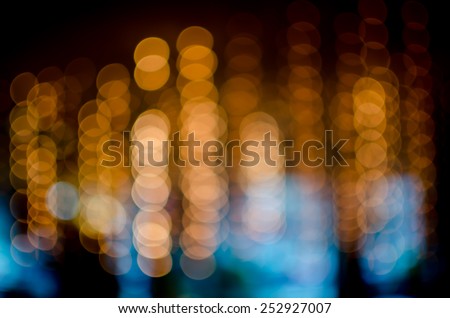 stock photo blur light from Chandeliers in low light place colorful with orange blue green and black shade